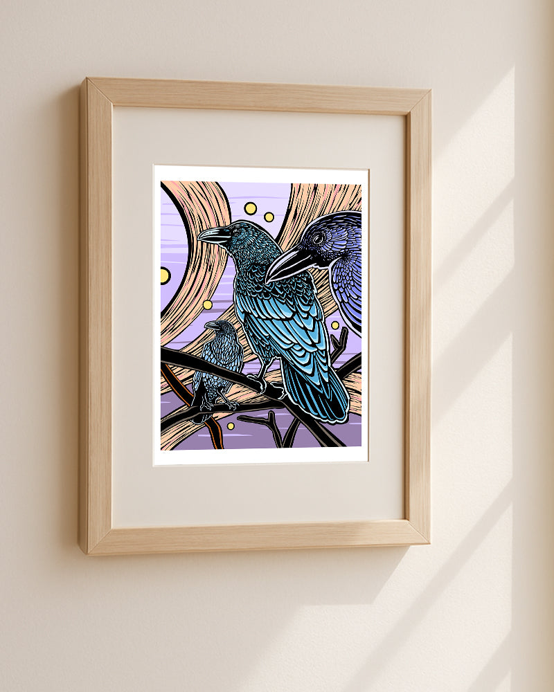 Framed artwork of three crows sitting on branches with a purple sky background hanging on a white wall.