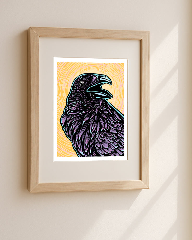 Framed artwork of a purple raven on a yellow background hanging in a white wall.