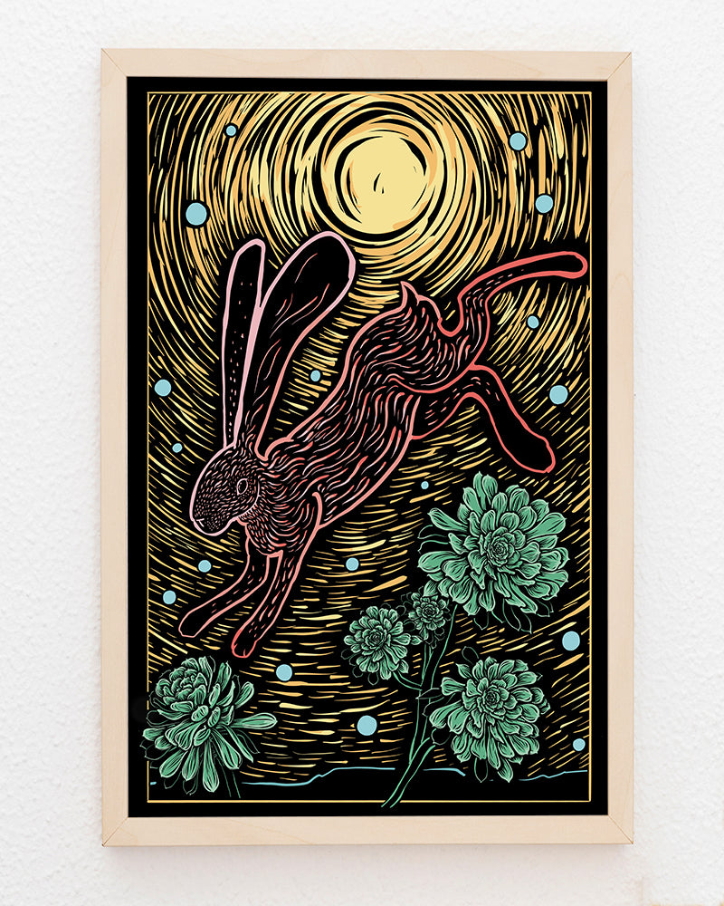 Framed artwork of a rabbit leaping over succulent plants with a bright yellow background. 