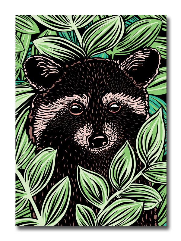 A card featuring a woodcut style illustration featuring a raccoon surrounded by green leaves.